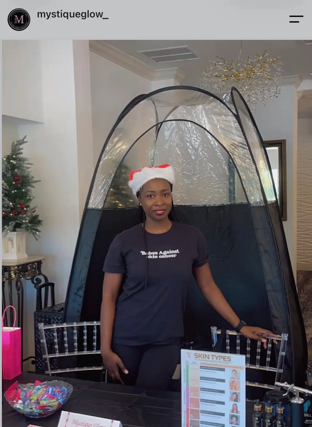 Spray tan artist wearing The Glo CEO apparel in her studio