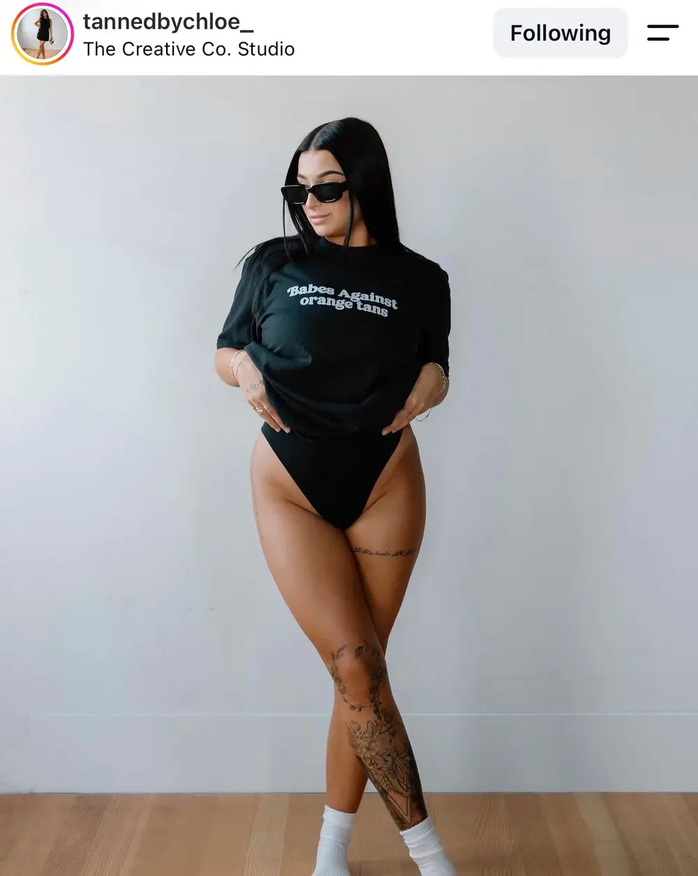 Spray tan artist wearing a Babes Against Orange Tans shirt
