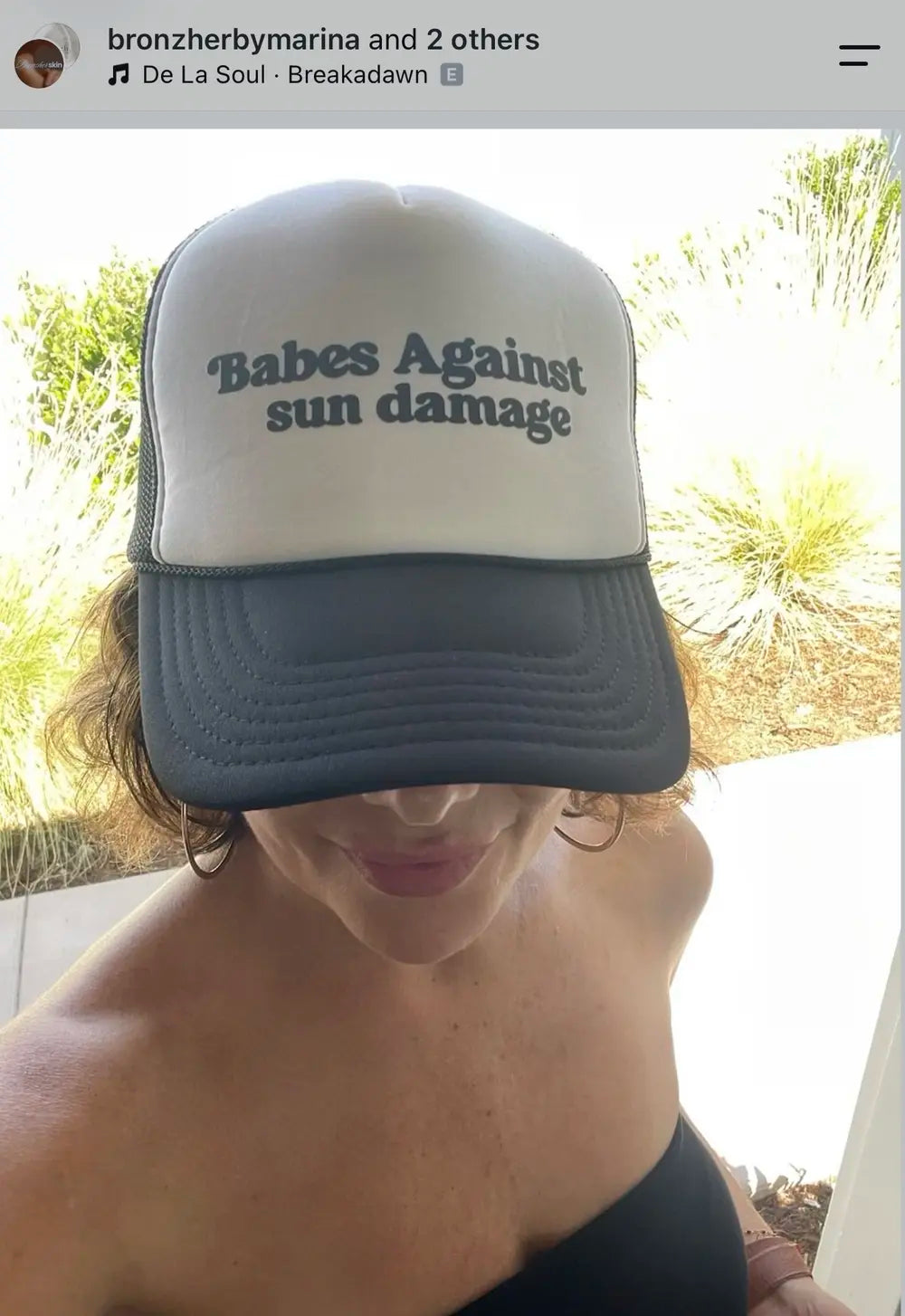 Spray tan artist wearing a Babes Against Sun Damage hat