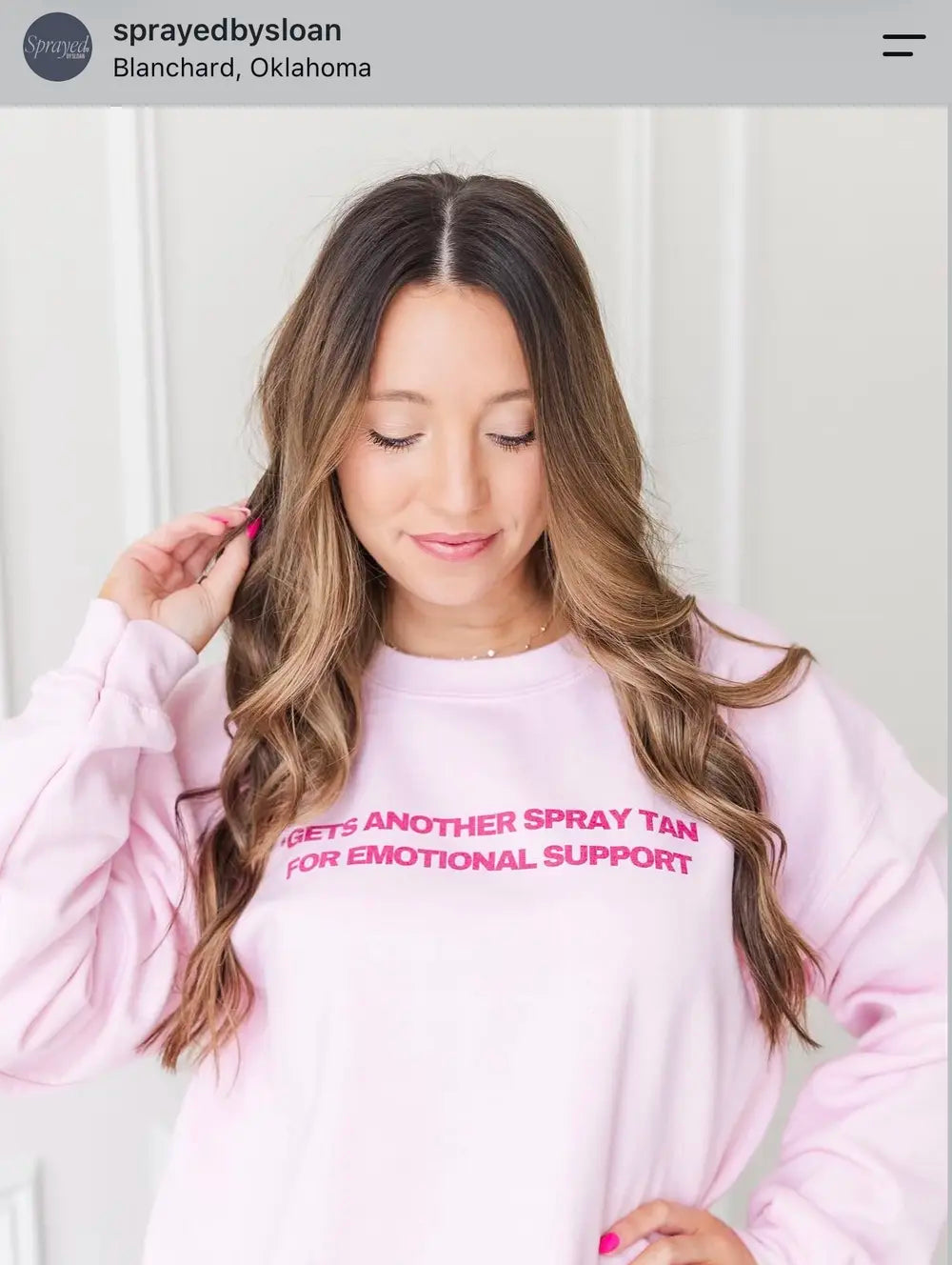 Spray tan artist wearing an emotional support spray tan sweatshirt